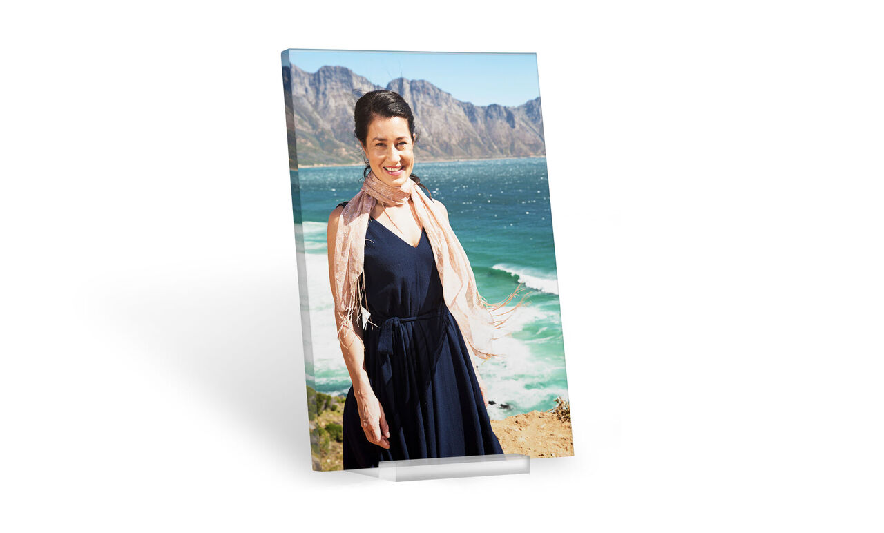Vrouw in een elegante jurk, omringd door een mooi kustlandschap