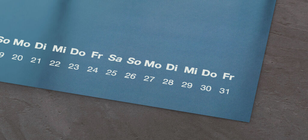 Kalenderblad met een blauwe achtergrond en weekdagen in wit, toont de maand.